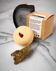 Bath Bomb with sandlewood and jasper on marble bathroom counter
