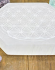 Flower of Life Engraved Selenite Plate on wood background angled | Goddess Provisions