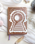 Stunning Gold/champaign planner decorative 2026 Moon Planners / notebooks with 2026 design on a white surface with candles and crystals. Goddess Provisions Planner - Exclusive