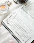 Inside pages of the 2026 planner featuring guided prompts, moon cycle references, and planning spreads.