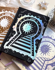 Stunning black planner decorative 2026 Moon Planners / notebooks with 2026 design on a white surface with candles and crystals. Goddess Provisions Planner - Exclusive. With champaign 2026 planner and Silver 2026 planner in the background.