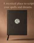 Black leather-bound book with moon design on cover against a brown background