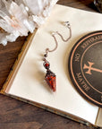Handcrafted red jasper and copper pendulum for grounding and spiritual work.