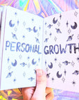 Dreamy moons manifest workbook featuring journal prompts and vision boards. Available at Goddess Provisions