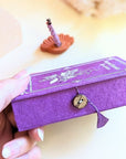 Stupa Smoke Rope Incense and womans hand holding the box. Available at Goddess Provisions