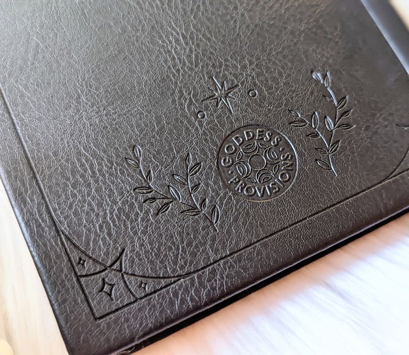 Mystical Musings Divination Diary showing a clear quartz crystal design surrounded by moon phases, ideal for amplifying dreams and manifestations.