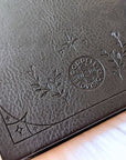 Mystical Musings Divination Diary showing a clear quartz crystal design surrounded by moon phases, ideal for amplifying dreams and manifestations.