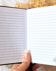A5 celestial journal made from recycled paper, with 120 lined pages and embossed moon phases design on black vegan leather. Perfect for magical moments and daily to-dos.