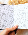 A5 celestial journal made from recycled paper, with 120 lined pages and embossed moon phases design on black vegan leather. Perfect for magical moments and daily to-dos.