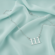 Gold-toned 111 angel number necklace representing intuition and alignment.