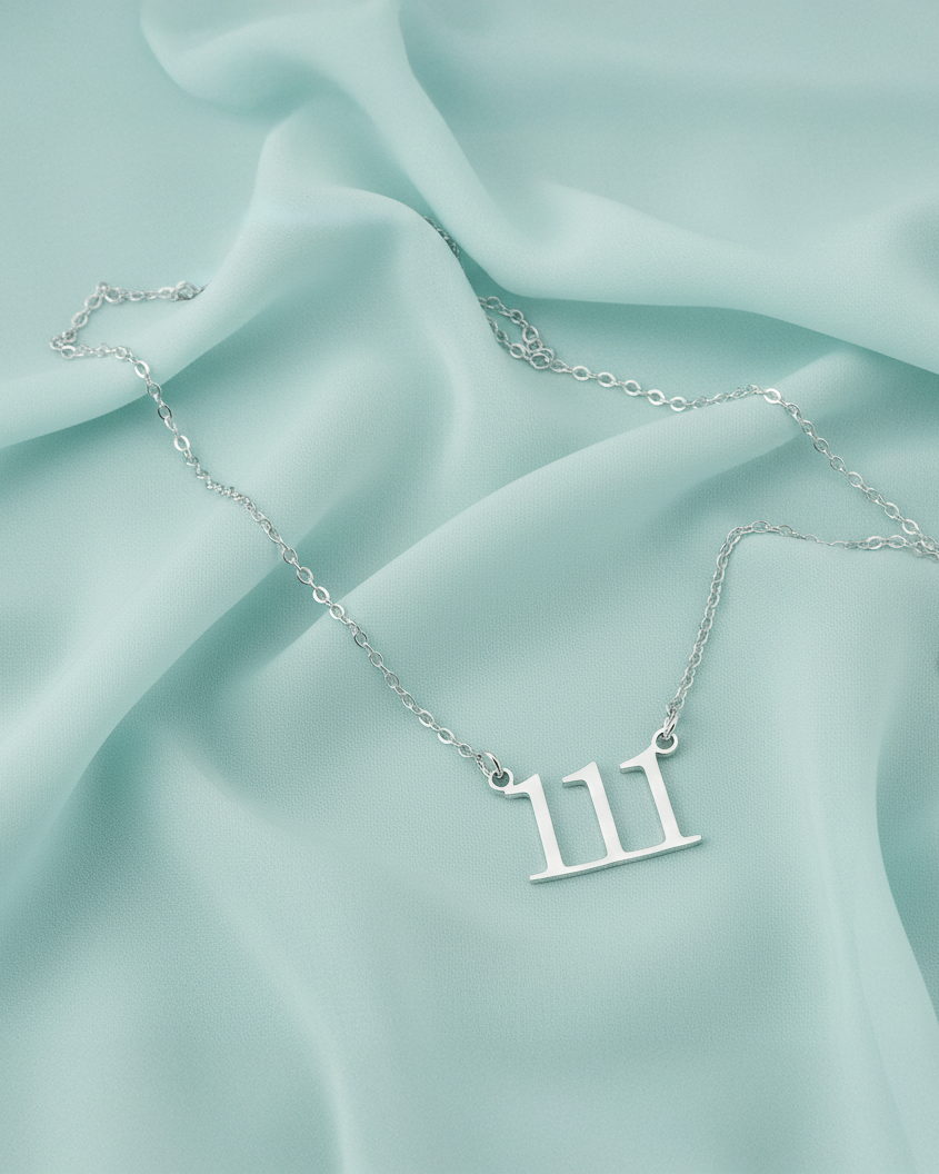 Gold-toned 111 angel number necklace representing intuition and alignment.