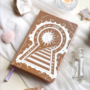 Stunning Decorative 2026 Moon Planners / notebooks with 2026 design on a white surface with candles and crystals. 2026 planner. Witchy Planner 2026