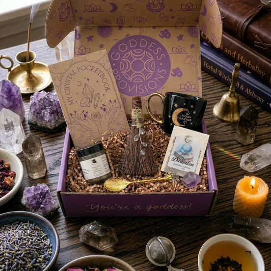 April subscription women box featuring crystal ritual set with tea, notebook, spoon, facial steam, broom, and amethyst crystal
