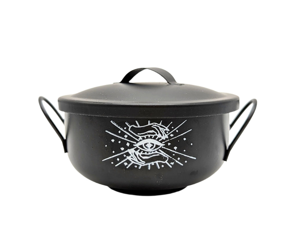 Black Mystical Cauldron with white background and white logo of an eye and two hands on the front. Available at Goddess Provisions