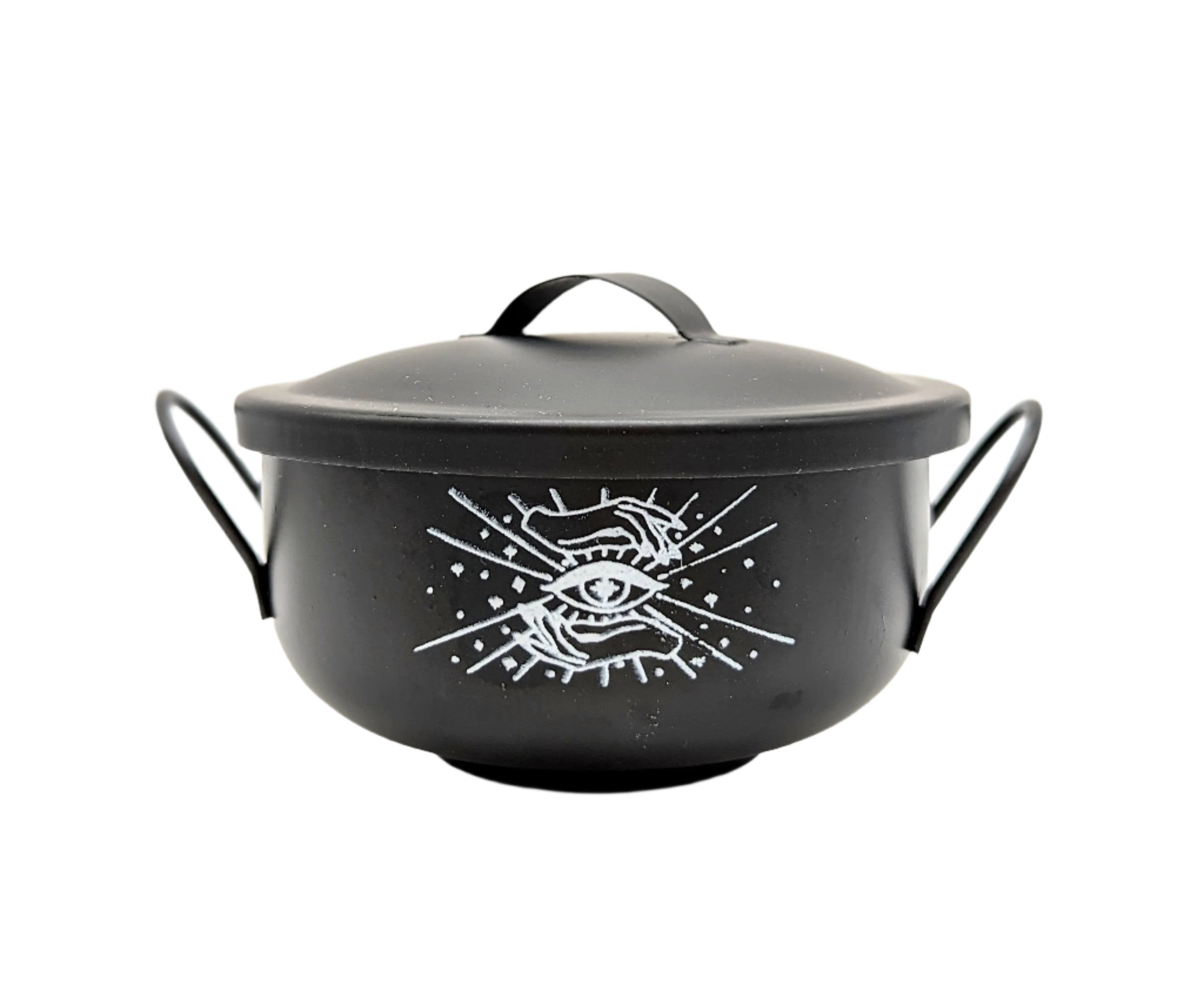Black Mystical Cauldron with white background and white logo of an eye and two hands on the front. Available at Goddess Provisions