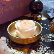 White candle with rose design symbolizing peace, purity, and honoring ancestors.