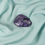 Tumbled Charoite crystal associated with intuition, psychic development, and the Third Eye.