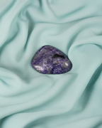 Tumbled Charoite crystal associated with intuition, psychic development, and the Third Eye.