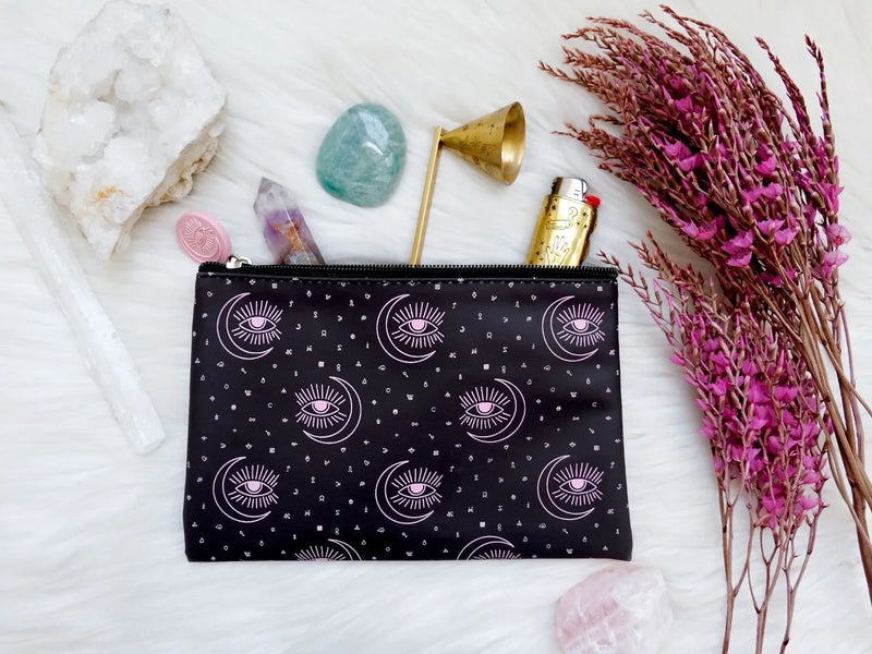 Color-changing ritual pouch displayed open with beauty essentials and magical accessories inside.