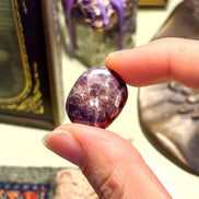 Raw Iolite gemstone showing natural indigo tones and smooth texture