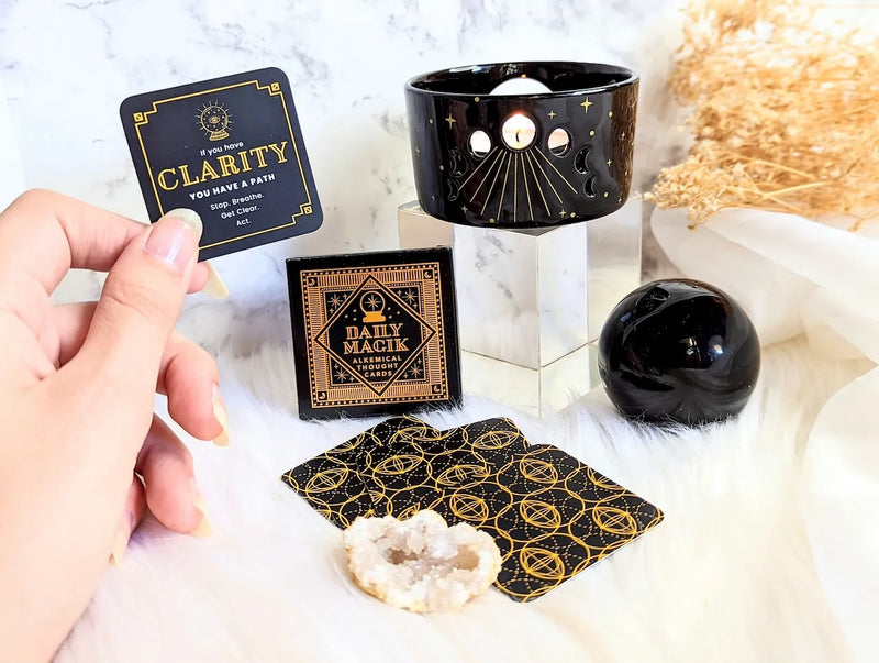 Pocket-sized Daily Magik cards styled in a cozy journaling setup with spiritual tools and tea.