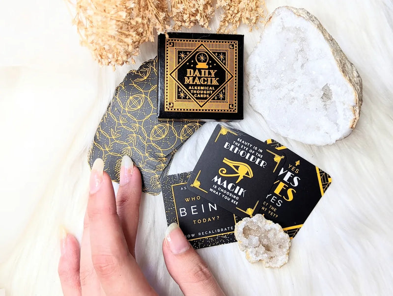 Compact inspirational card deck spread out on a mystical altar with celestial decor accents.