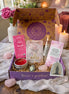 Divine Feminine subscription box featuring oracle deck, bath soak, chocolate bar, clay mask, candle, crystal, and sticker,
