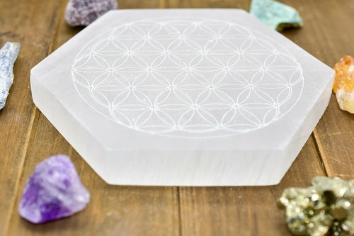 Flower of Life Engraved Selenite Plate on wood background angled | Goddess Provisions