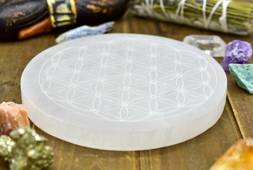 Flower of Life Engraved Selenite Plate on wood background angled | Goddess Provisions