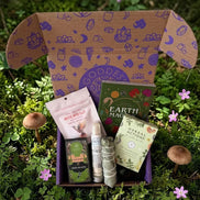 wellness subscription box with herbal flashcards, mushroom gummies, oils, foot soak, eucalyptus, and moss agate crystal