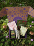 wellness subscription box with herbal flashcards, mushroom gummies, oils, foot soak, eucalyptus, and moss agate crystal
