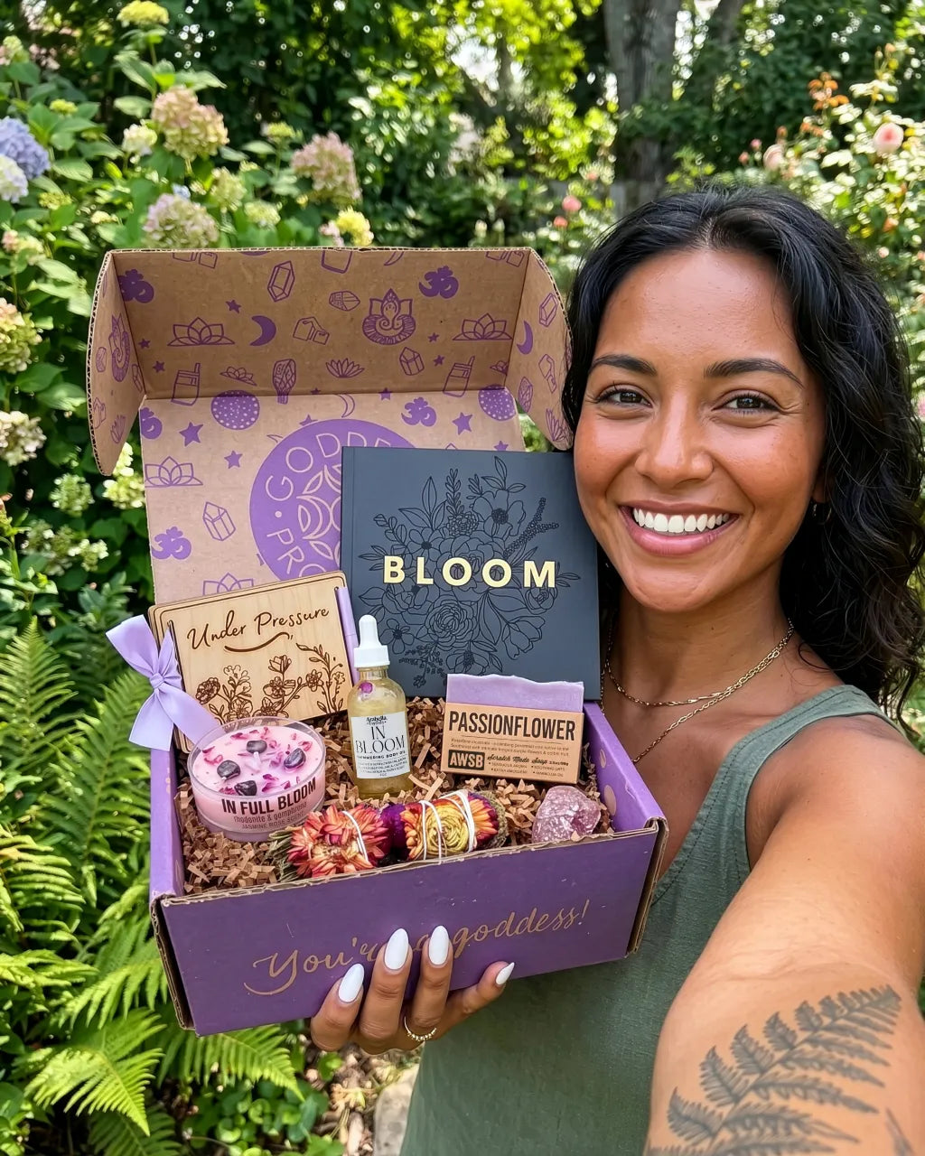 In Bloom spiritual subscription box with self care rituals, lavender smudge wand, body oil, crystal candle, and healing crystal