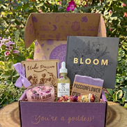 May Goddess Provisions subscription box featuring shimmer oil, crystal candle, flower press, soap, smudge wand, and cherry quartz