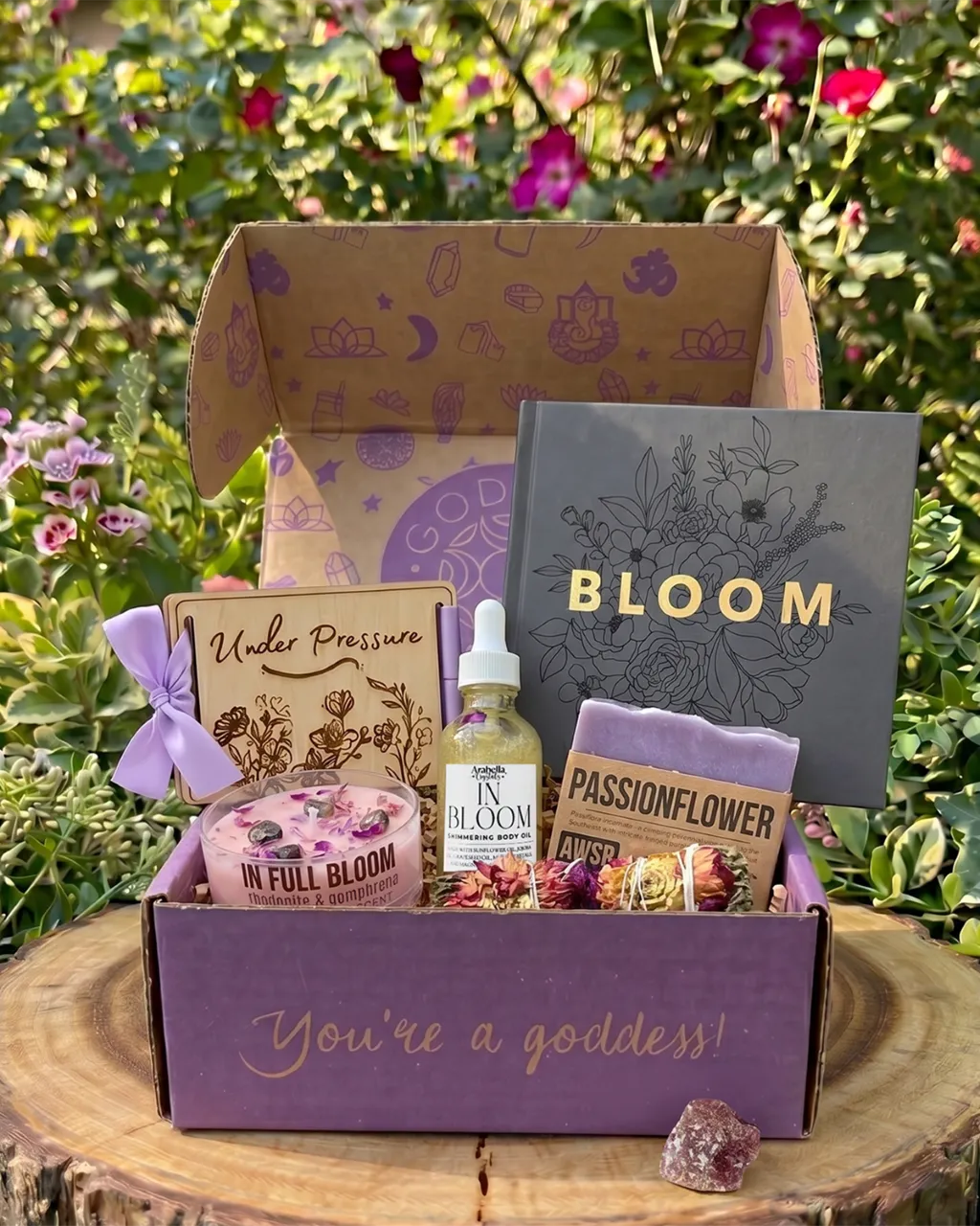 May Goddess Provisions subscription box featuring shimmer oil, crystal candle, flower press, soap, smudge wand, and cherry quartz