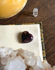 Heart-shaped garnet and astrophyllite stone for passion and spiritual insight.