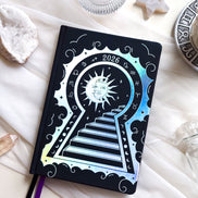 2026 planner in black vegan leather with silver holographic design.