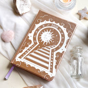Stunning Decorative 2026 Moon Planners / notebooks with 2026 design on a white surface with candles and crystals. 2026 planner. Witchy Planner 2026