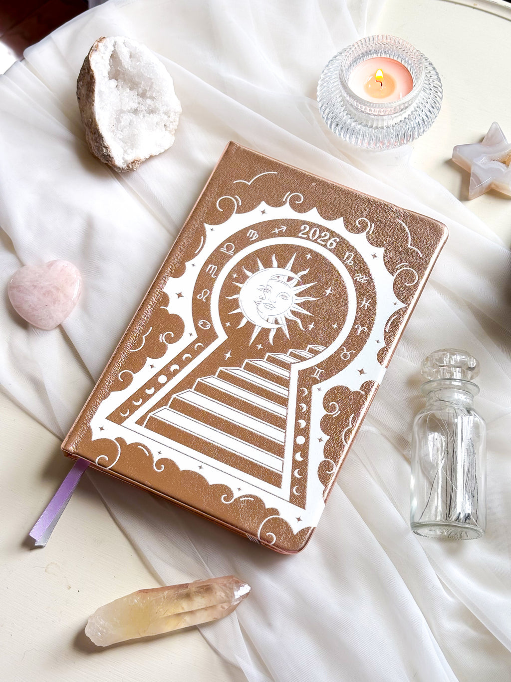 Stunning Decorative 2026 Moon Planners / notebooks with 2026 design on a white surface with candles and crystals. 2026 planner. Witchy Planner 2026