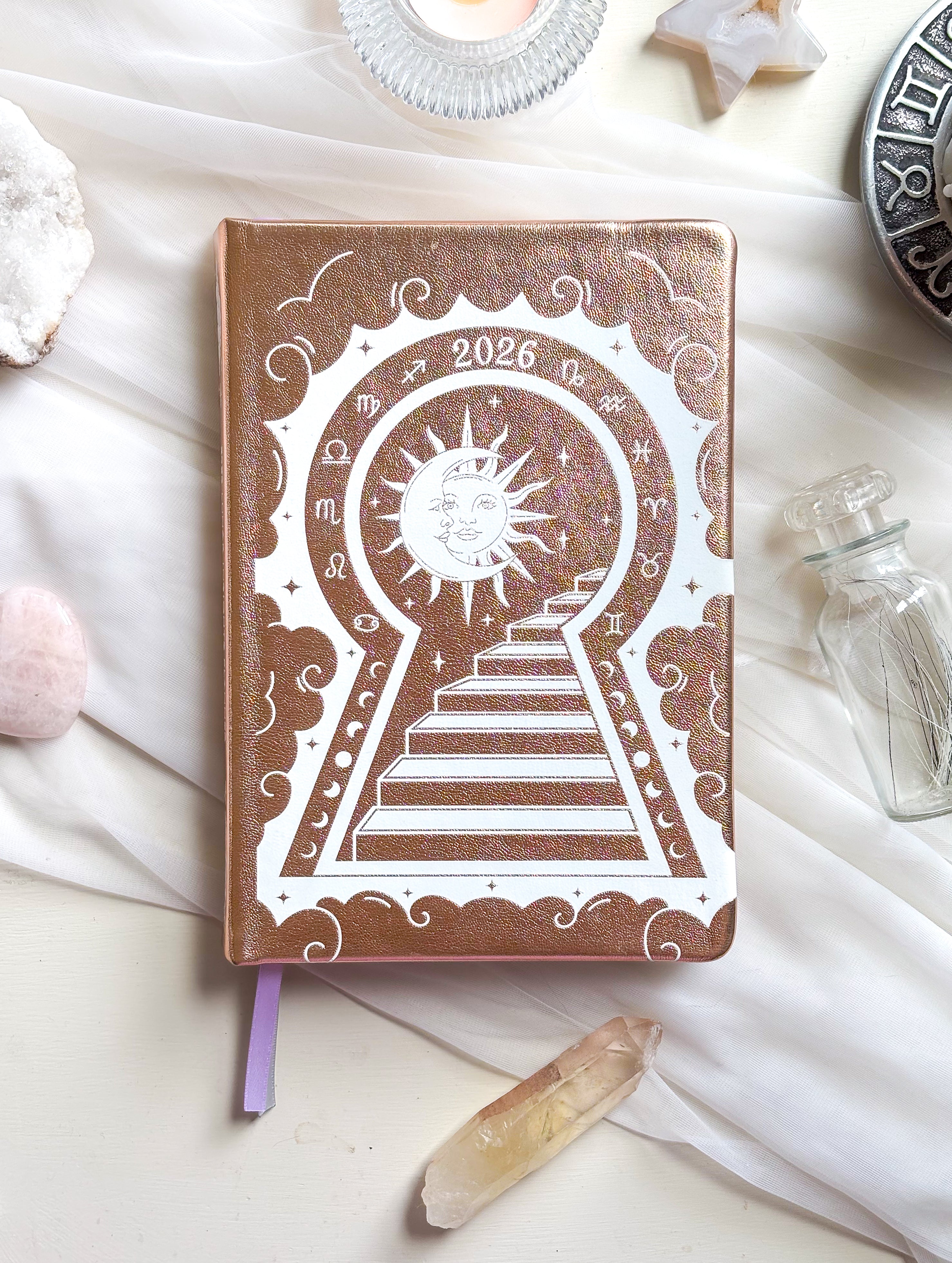 Stunning Gold/champaign planner decorative 2026 Moon Planners / notebooks with 2026 design on a white surface with candles and crystals. Goddess Provisions Planner - Exclusive