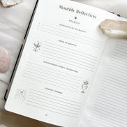 Interior pages of the 2026 planner showing monthly and weekly layouts, goal sections, and intention prompts.