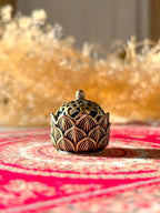 Ceramic hollow lotus incense burner with delicate floral cutouts for aromatherapy and meditation décor.