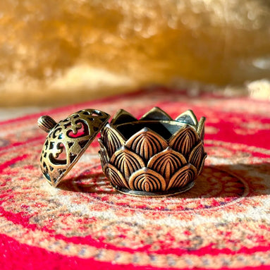 Lotus-shaped ceramic incense holder used for burning incense in yoga, meditation, or home altar spaces.