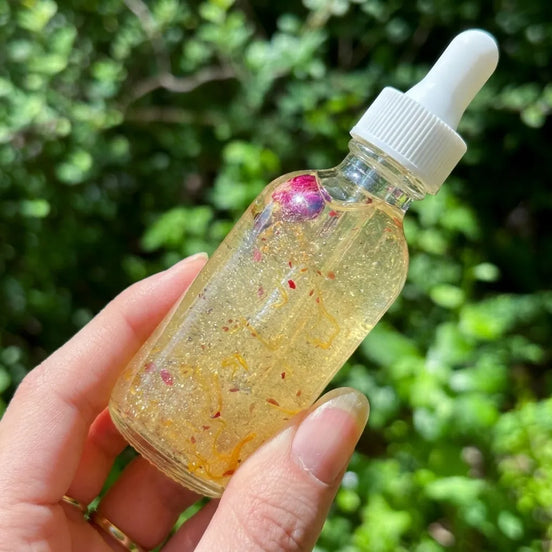 hydrating shimmer body oil with sunflower, jojoba, and grapeseed oils, rose petals, and jasmine buds