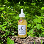 glowing body oil with biodegradable shimmer and botanical flowers for soft, luminous skin
