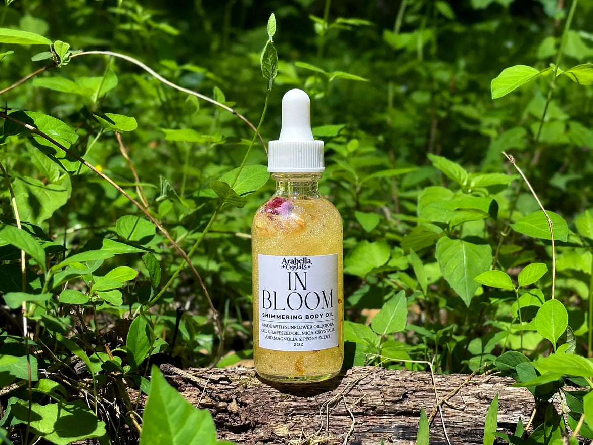 glowing body oil with biodegradable shimmer and botanical flowers for soft, luminous skin