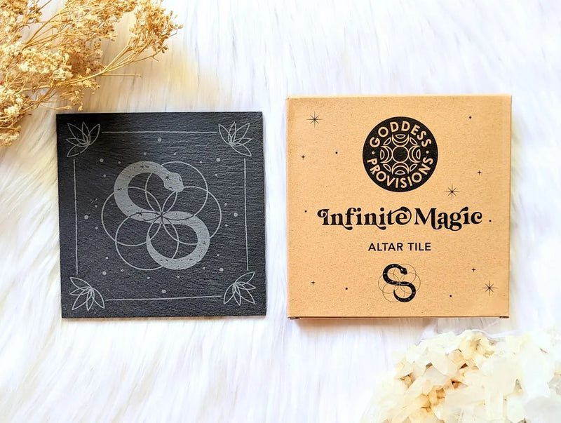 Square slate altar tile with symbolic serpent artwork displayed in a minimal sacred space setup.