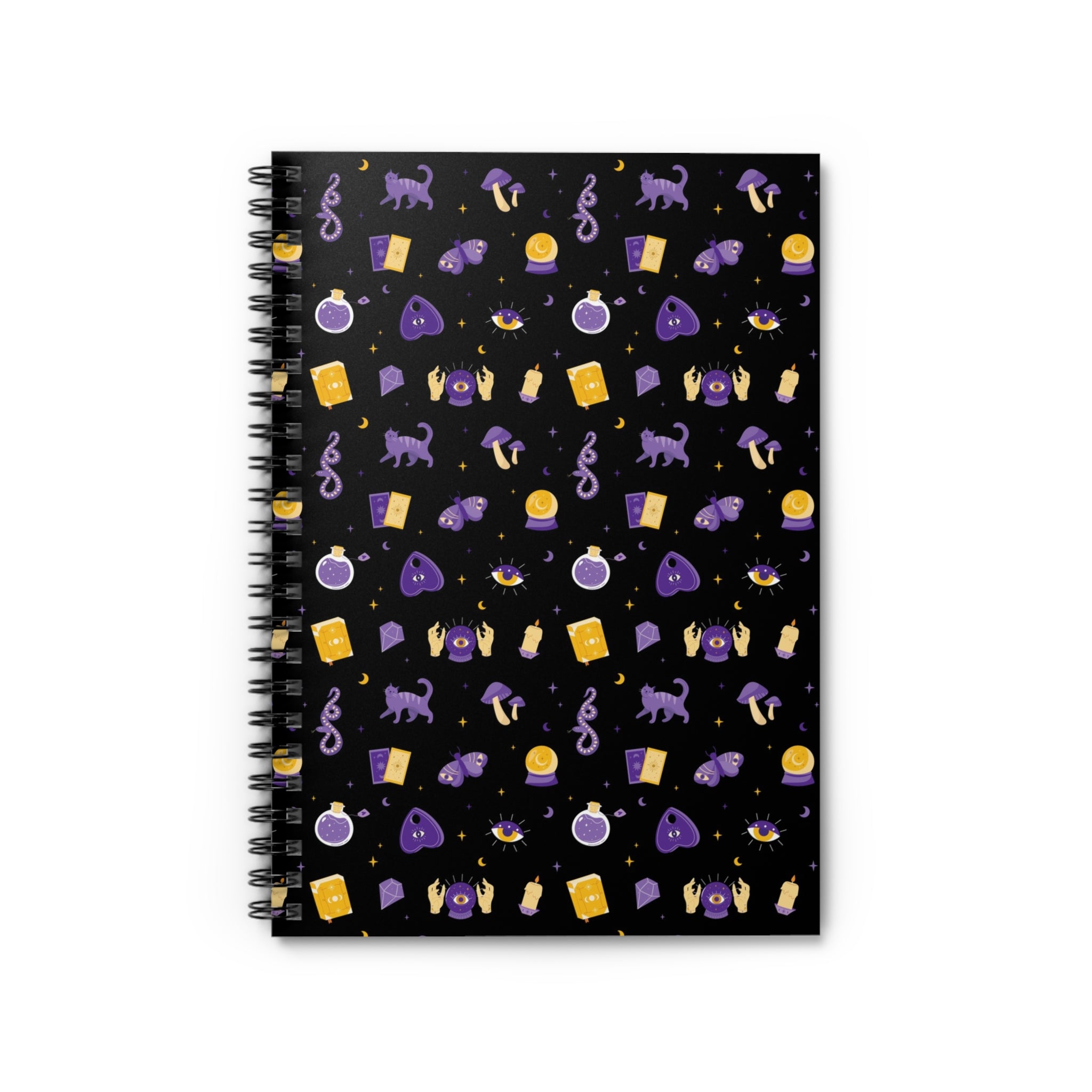 A spiral-bound journal with a black cover featuring a whimsical witch design with various symbols and shapes in purple, gold, and white colors.