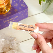 Natural mango sorbet lip balm in eco-friendly packaging for plant-based lip care.