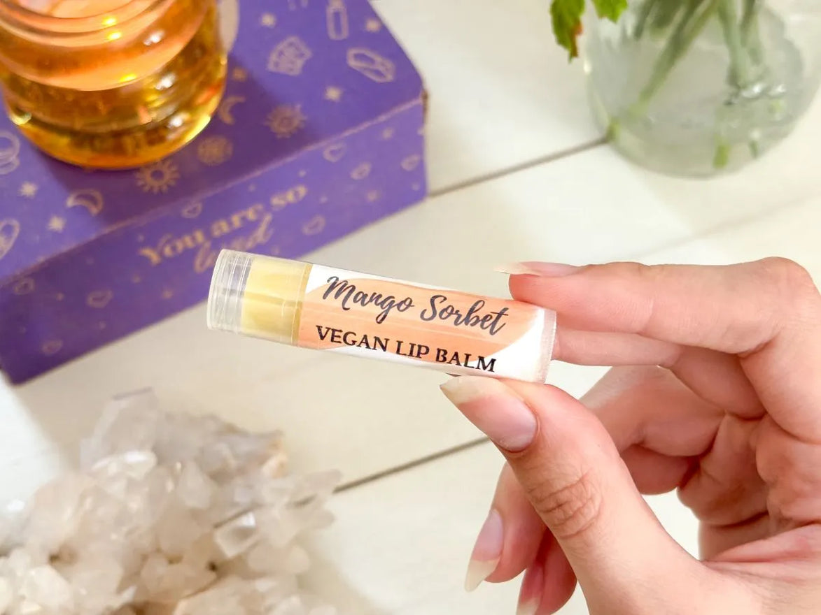 Natural mango sorbet lip balm in eco-friendly packaging for plant-based lip care.