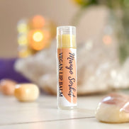 Organic vegan lip balm labeled Juicy Mango Sorbet with tropical mango flavor.